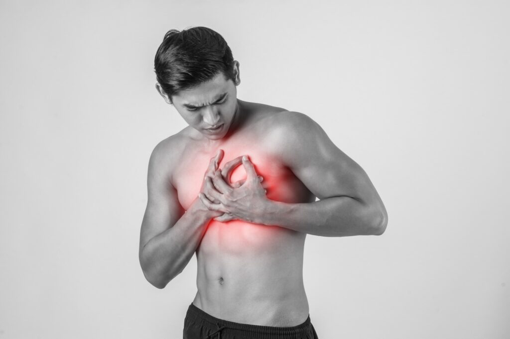 A man clutches his chest in pain in the setting of heart disease from atherosclerosis. This leading cause of death is preventable with lifestyle factors and pharmaceuticals. 